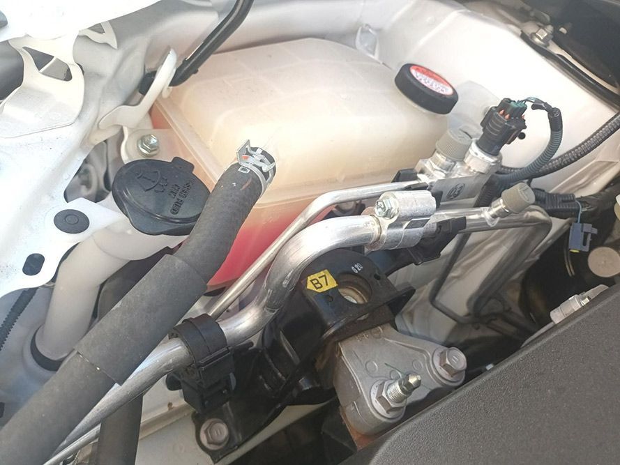 A Close Up of the Underside of a Car with a Water Tank and Hose — South West 4WD Wreckers In Brisbane, QLD