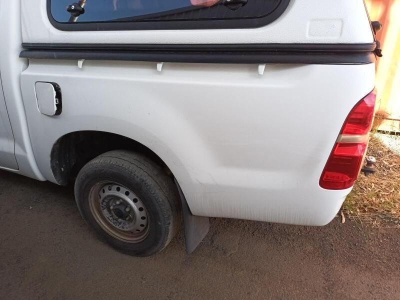 A White Truck With a Canopy is Parked on the Side of the Road — South West 4WD Wreckers In Brisbane, QLD