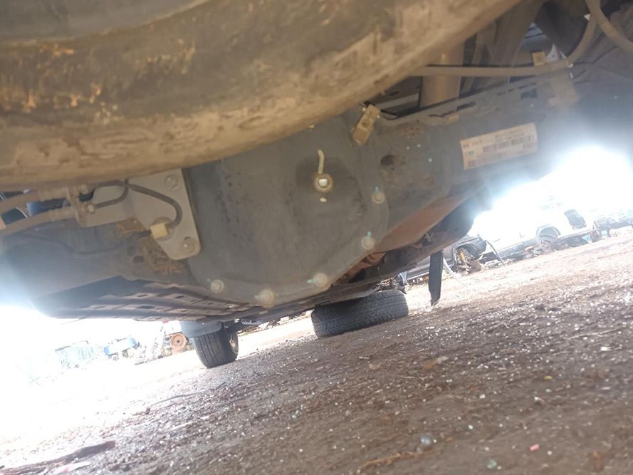 The Underside of a Car is Shown in a Parking Lot — South West 4WD Wreckers In Brisbane, QLD