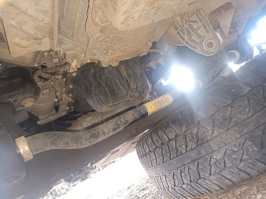 A Close Up of the Underside of a Car with a Tire in the Foreground — South West 4WD Wreckers In Brisbane, QLD