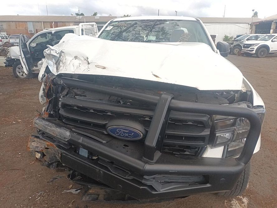 A White Ford Truck with a Black Bumper is Sitting in a Parking Lot — South West 4WD Wreckers In Brisbane, QLD