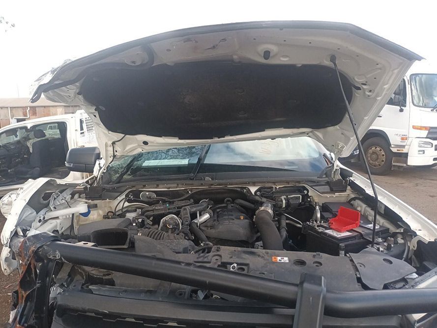The Hood of a White Truck is Open and the Engine is Visible — South West 4WD Wreckers In Brisbane, QLD