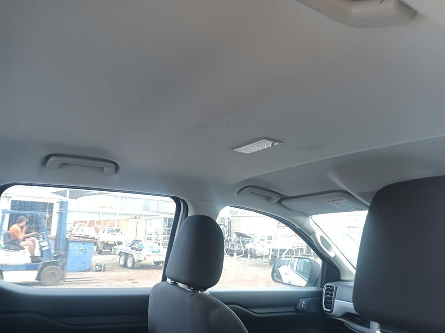 A Car is Parked in a Parking Lot and the Ceiling is Visible — South West 4WD Wreckers In Brisbane, QLD