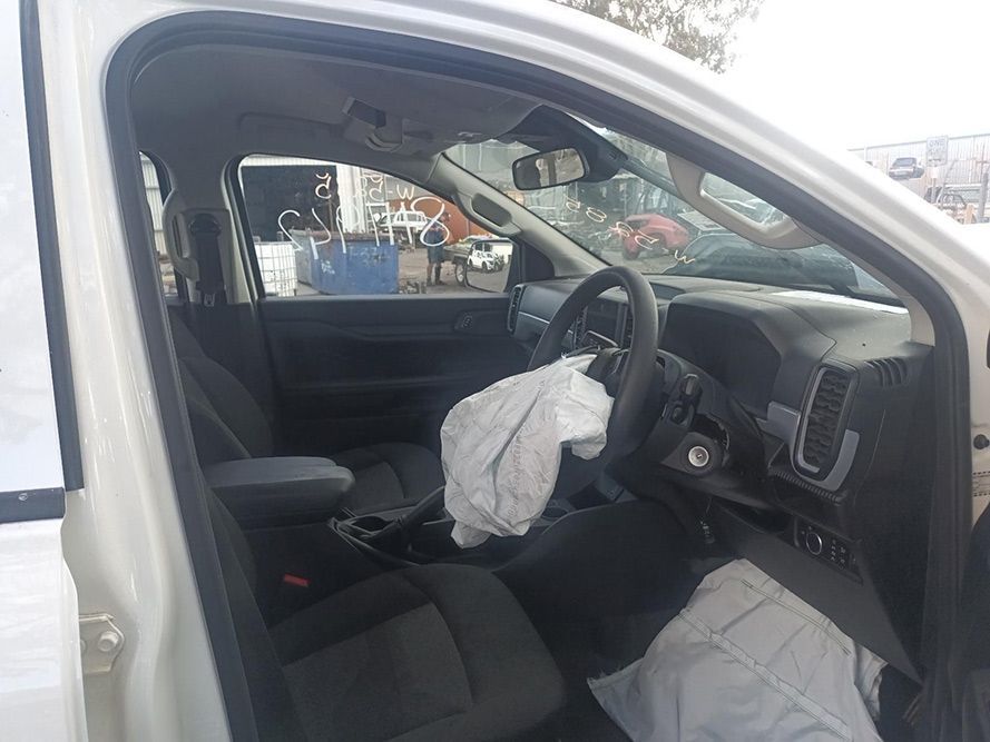 The Inside of a White Car with a Broken Airbag — South West 4WD Wreckers In Brisbane, QLD