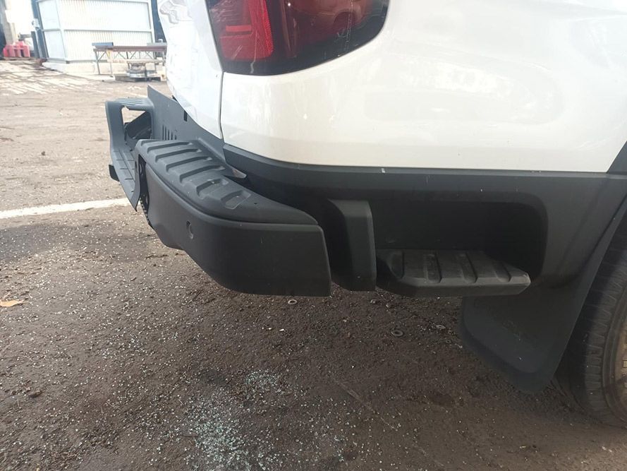A White Truck with a Black Bumper is Parked in a Parking Lot — South West 4WD Wreckers In Brisbane, QLD