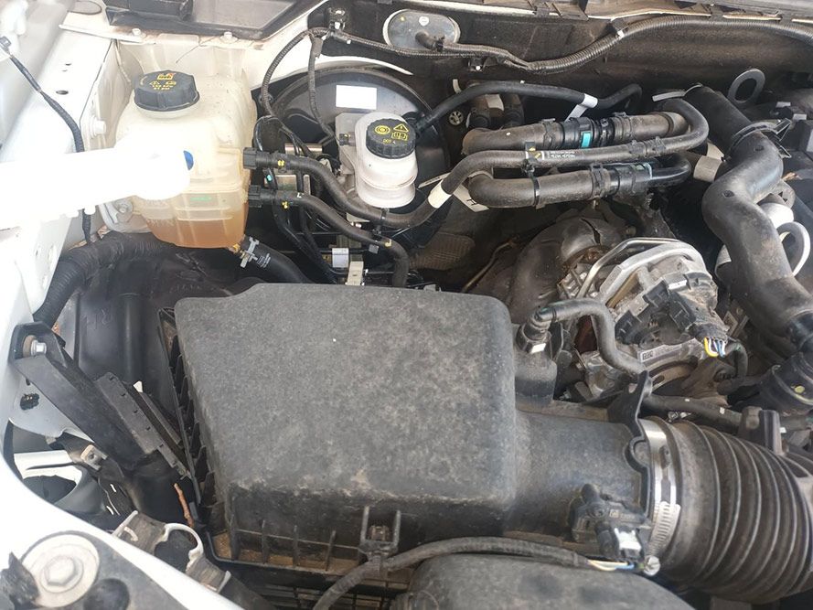 A Close Up of the Engine of a White Car — South West 4WD Wreckers In Brisbane, QLD