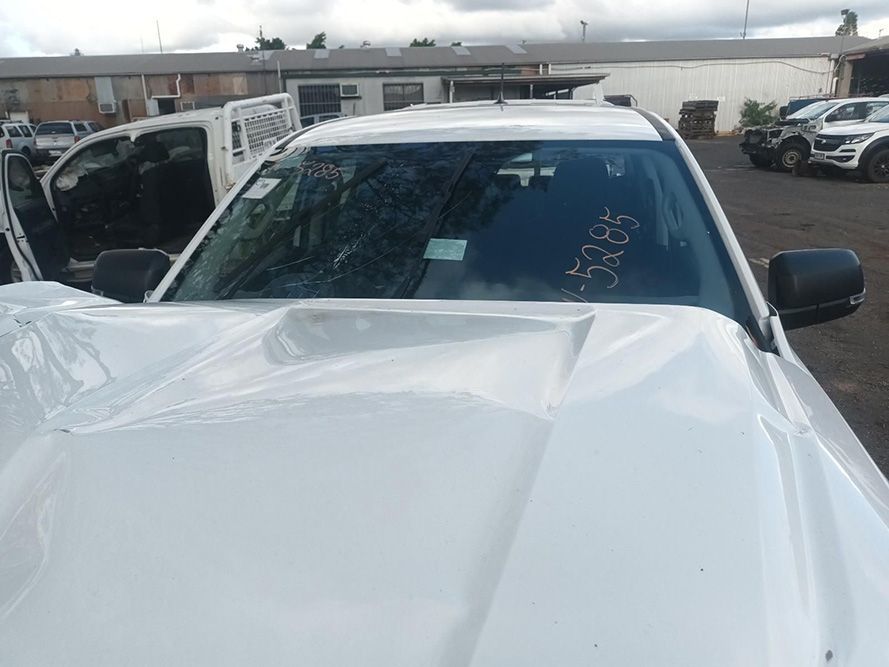A White Truck with a Broken Windshield is Parked in a Parking Lot — South West 4WD Wreckers In Brisbane, QLD