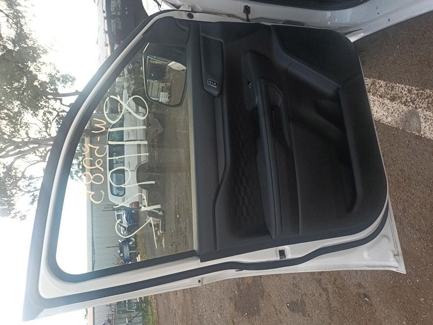 A White Car with the Door Open is Parked on the Side of the Road — South West 4WD Wreckers In Brisbane, QLD