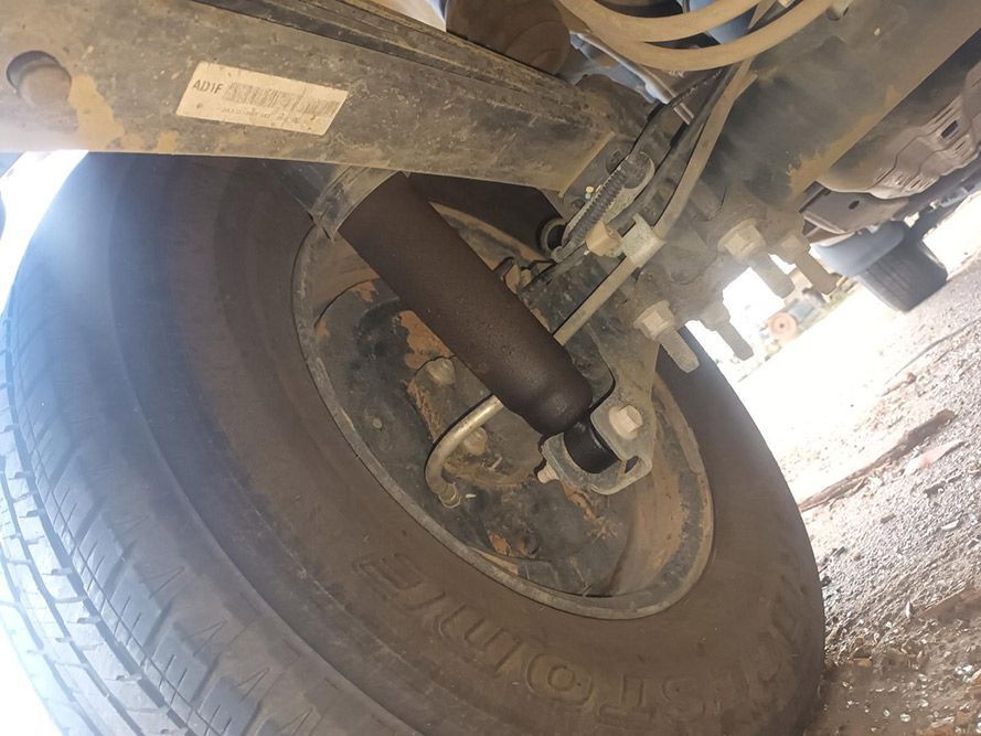 A Close Up of a Tire on a Car with a Shock Absorber Attached to It — South West 4WD Wreckers In Brisbane, QLD