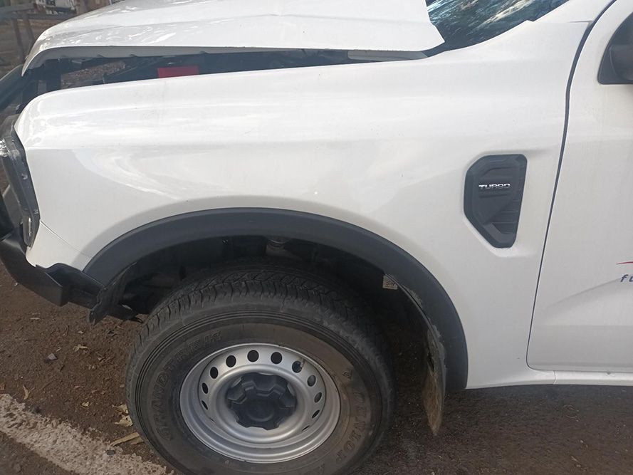 A White Truck with the Hood Up is Parked on the Side of the Road — South West 4WD Wreckers In Brisbane, QLD