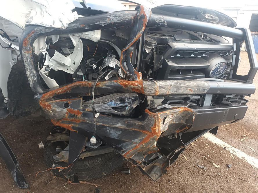 A Damaged Car is Sitting on the Ground in a Parking Lot — South West 4WD Wreckers In Brisbane, QLD