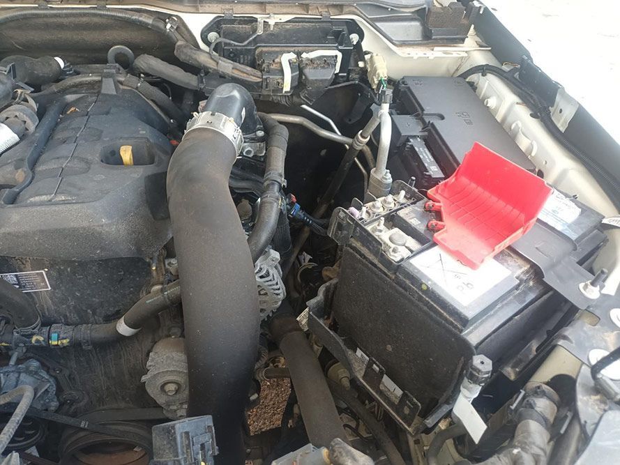 A Close Up of a Car Engine with a Red Battery Cover — South West 4WD Wreckers In Brisbane, QLD
