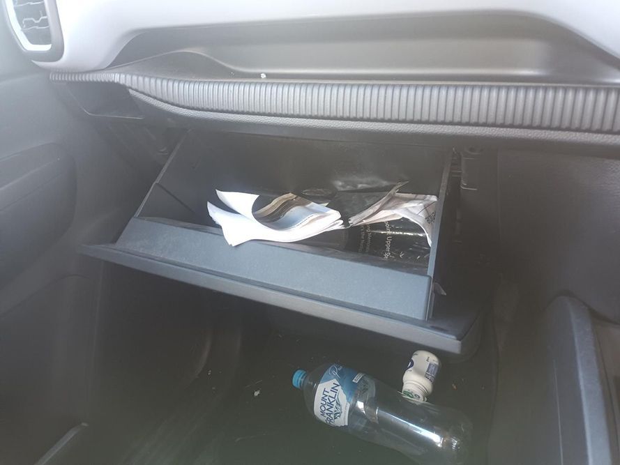 A Car Glovebox with a Bottle of Water and a Napkin in It — South West 4WD Wreckers In Brisbane, QLD
