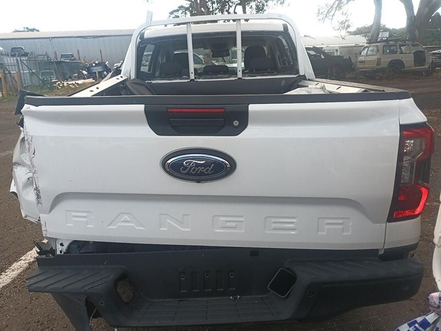 The Back End of a White Ford Ranger Truck is Damaged — South West 4WD Wreckers In Brisbane, QLD