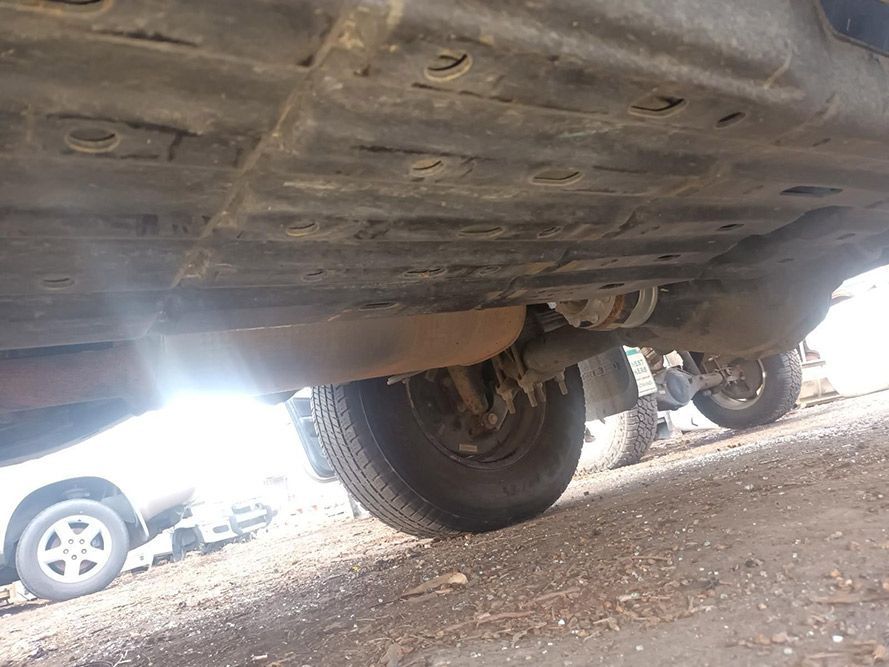 A Close Up of the Underside of a Car Parked on the Side of the Road — South West 4WD Wreckers In Brisbane, QLD