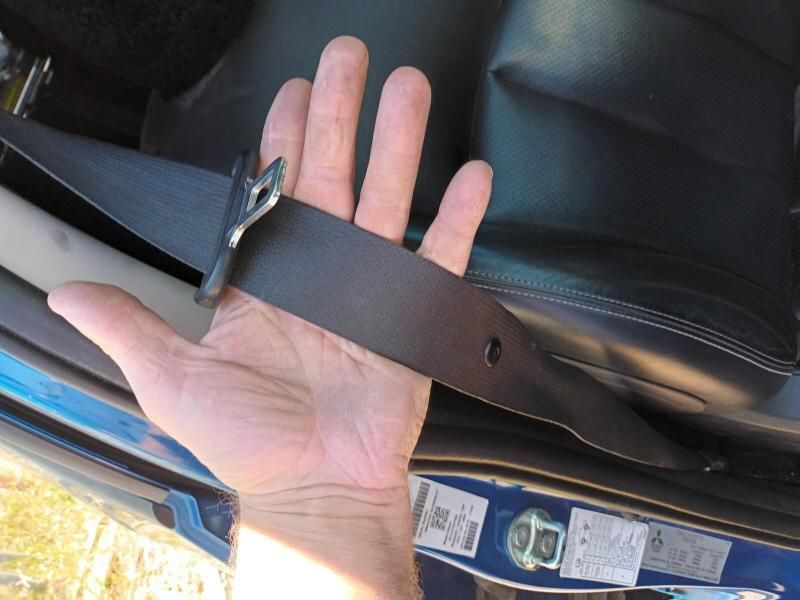 A Person is Holding a Seat Belt in Their Hand — South West 4WD Wreckers In Brisbane, QLD