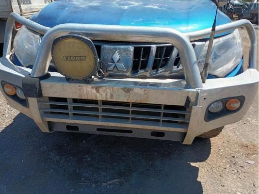 A Blue Mitsubishi Truck is Parked on a Dirt Road — South West 4WD Wreckers In Brisbane, QLD