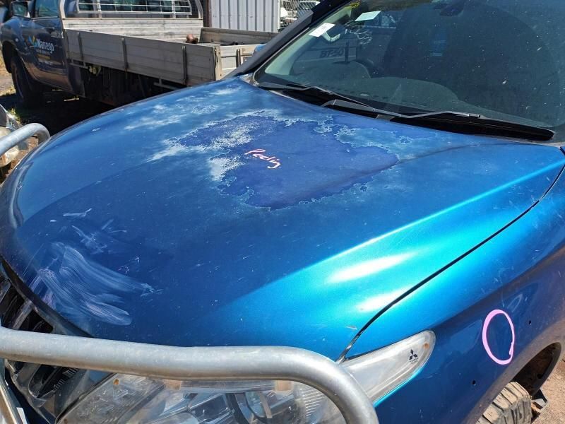 A Blue Car With a Broken Hood is Parked Next to a Truck — South West 4WD Wreckers In Brisbane, QLD