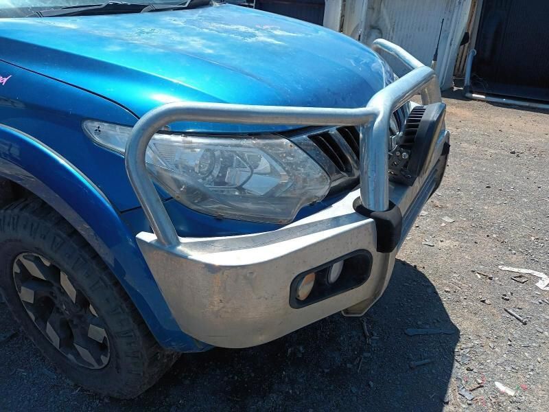 A Blue Truck With a Silver Bumper is Parked on the Side of the Road — South West 4WD Wreckers In Brisbane, QLD