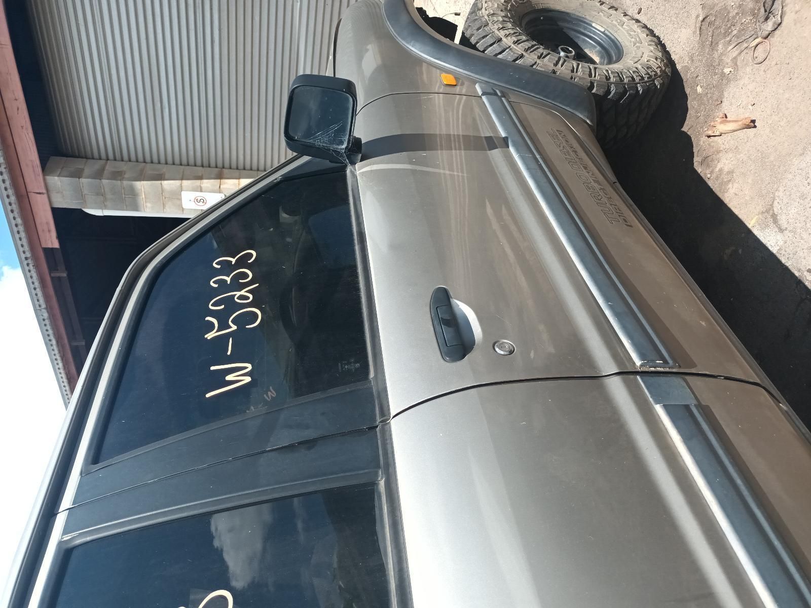 A Silver Car with a License Plate That Says W-5233 — South West 4WD Wreckers In Brisbane, QLD