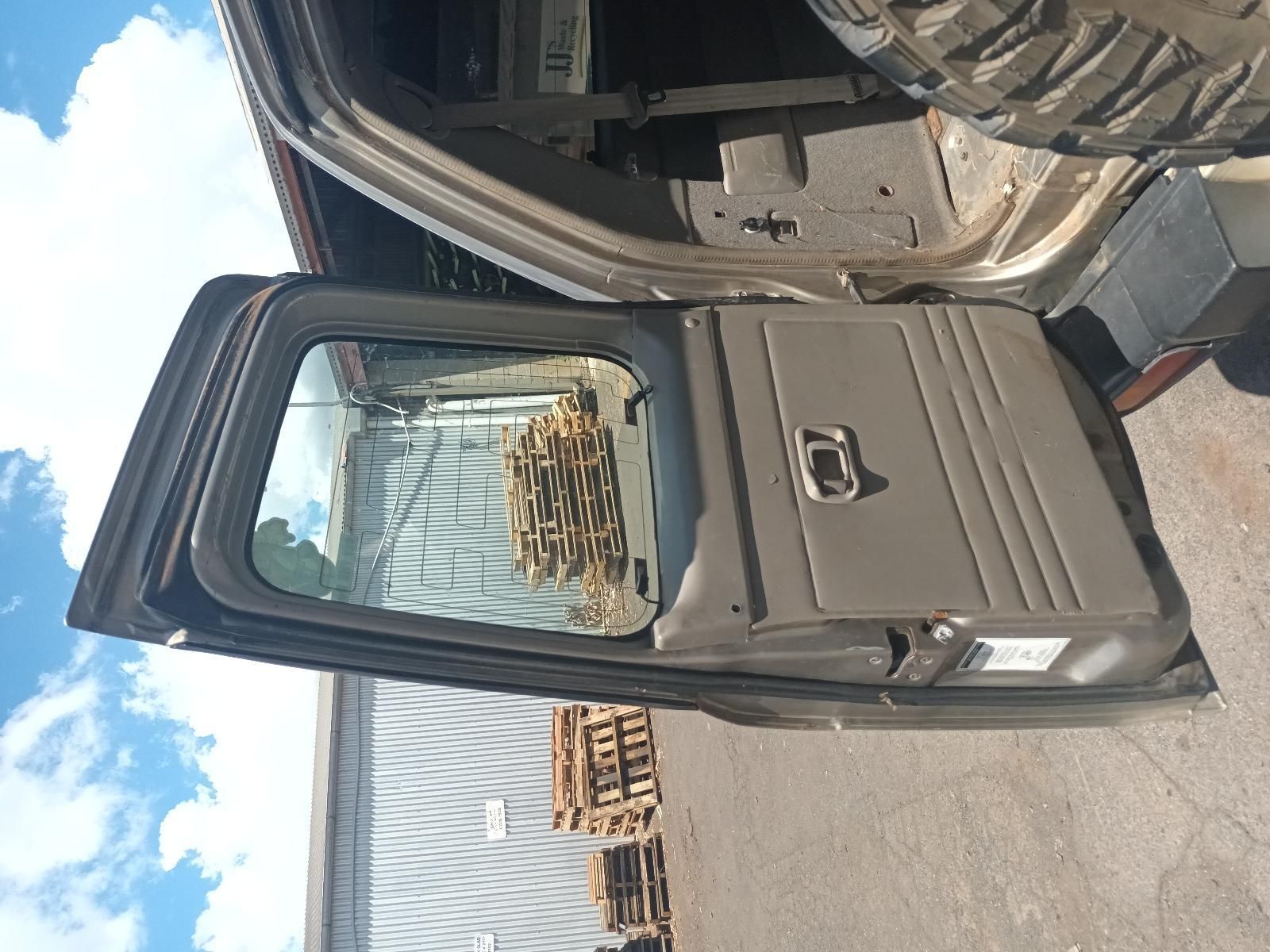 A Car with the Door Open is Parked in Front of a Building — South West 4WD Wreckers In Brisbane, QLD