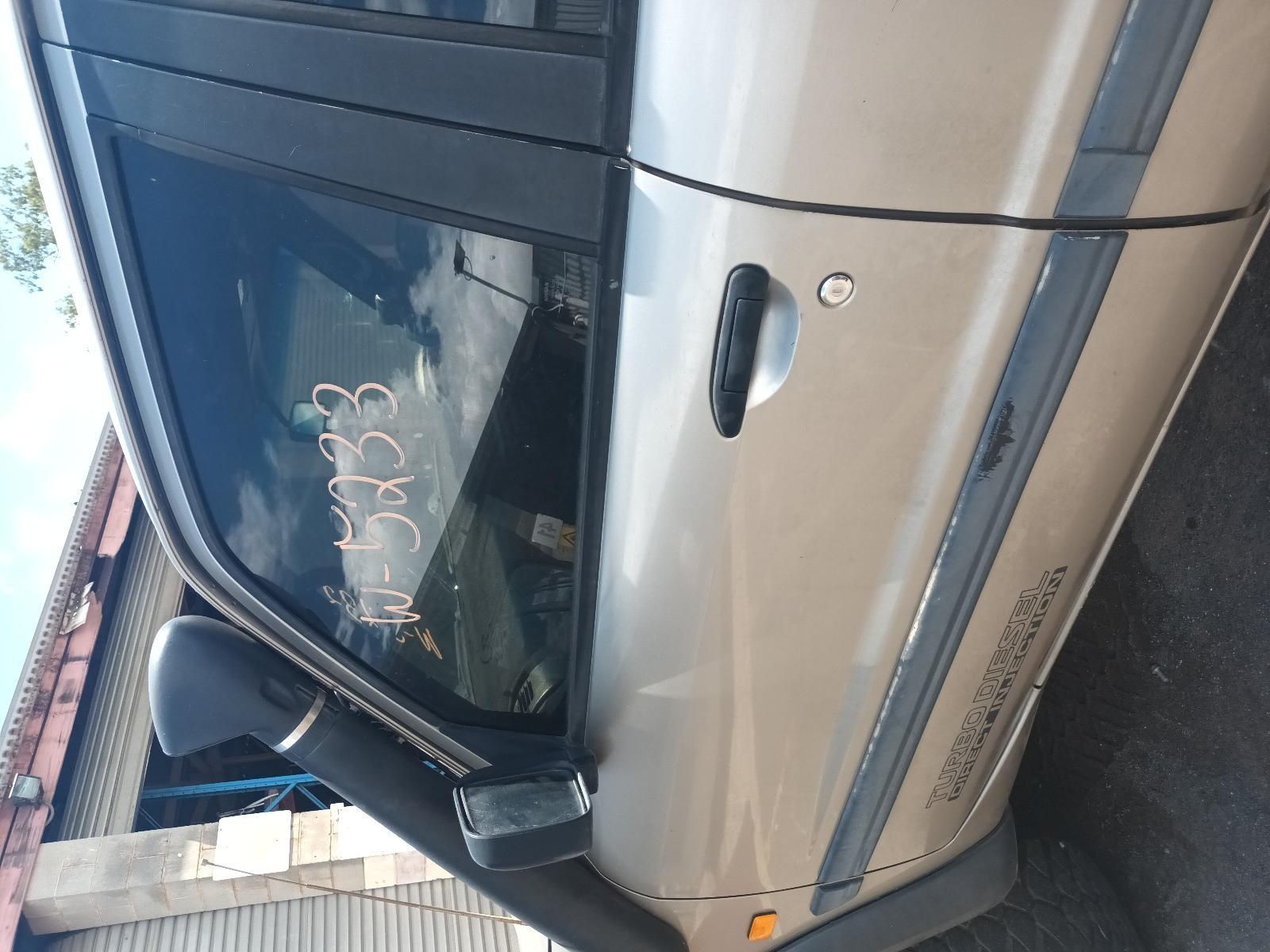 A Silver Car is Parked in Front of a Building— South West 4WD Wreckers In Brisbane, QLD