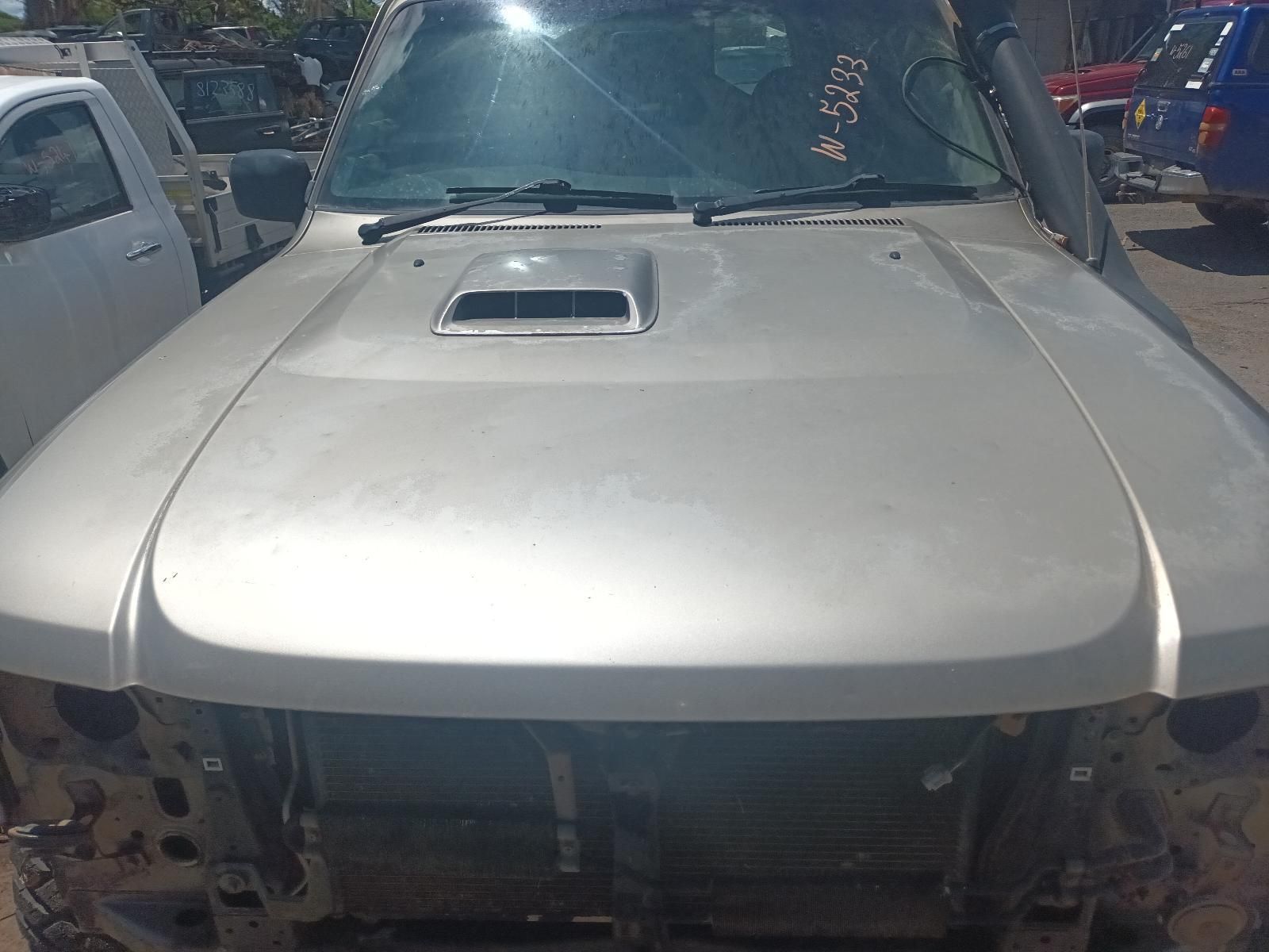 A Silver Car with the Hood Removed is Parked in a Parking Lot — South West 4WD Wreckers In Brisbane, QLD