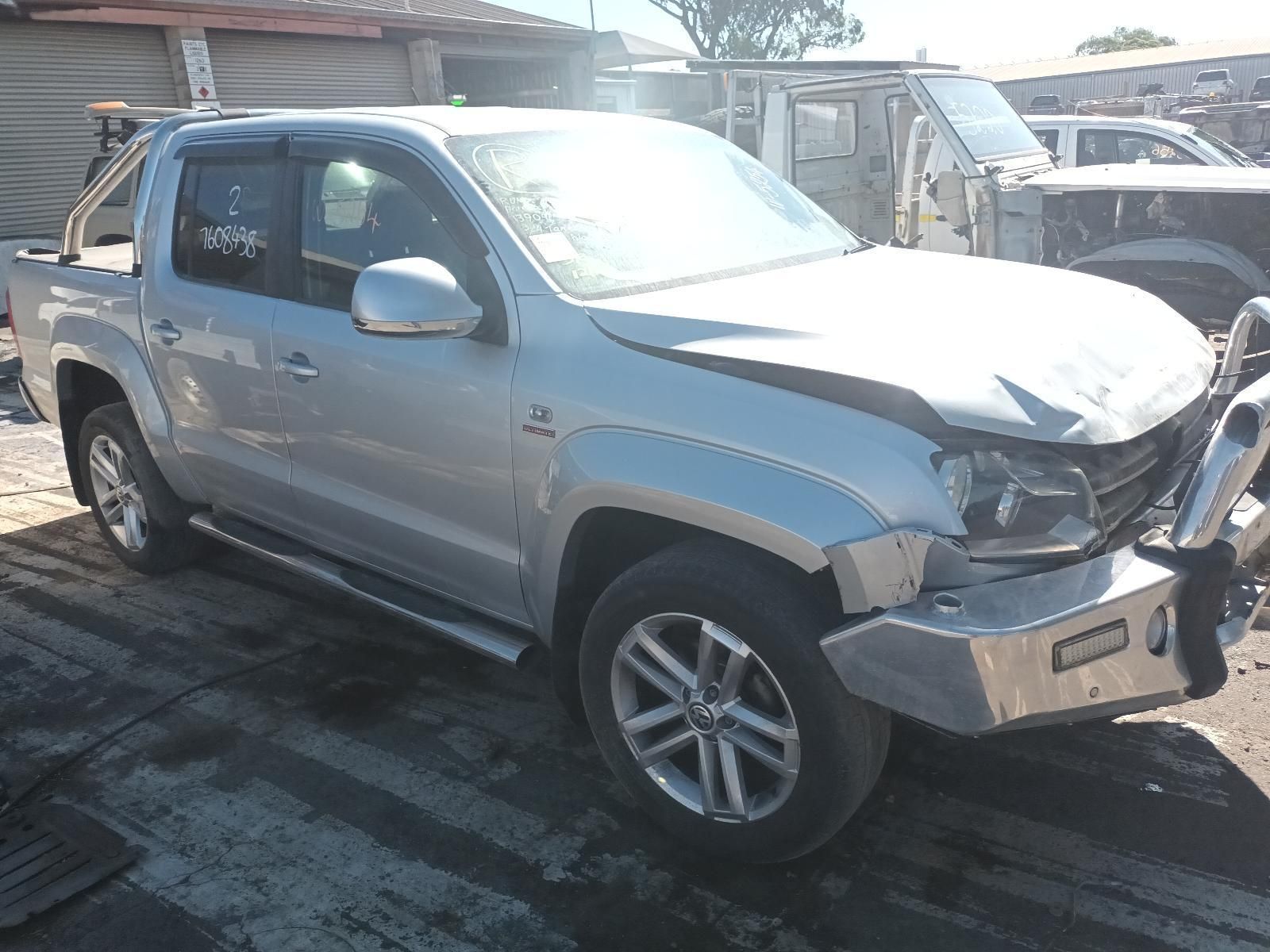 A Silver Truck with a Broken Bumper is Parked in a Parking Lot — South West 4WD Wreckers In Brisbane, QLD