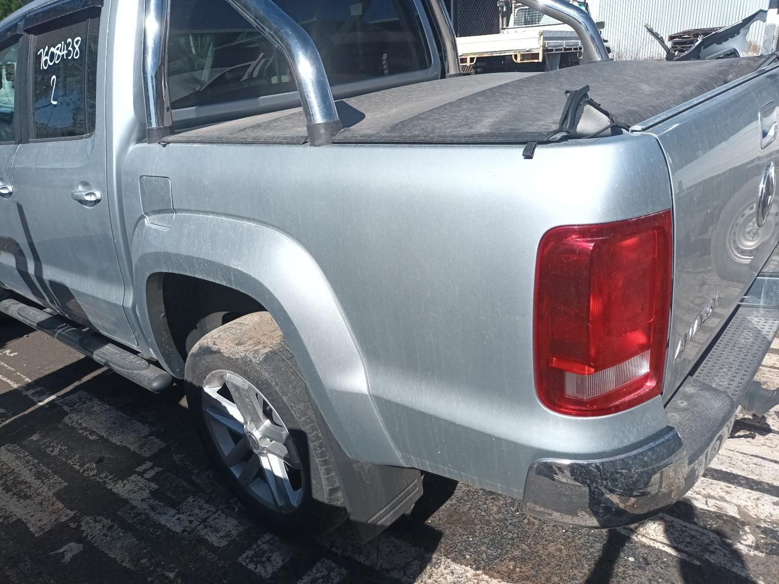 A Silver Truck with a Red Tail Light is Parked in a Parking Lot — South West 4WD Wreckers In Brisbane, QLD
