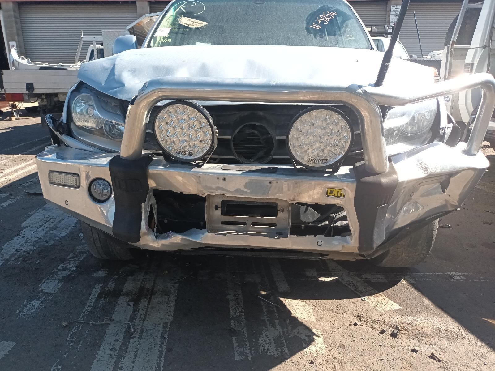 A Silver Truck with a Bumper and Lights on It is Parked on the Side of the Road — South West 4WD Wreckers In Brisbane, QLD