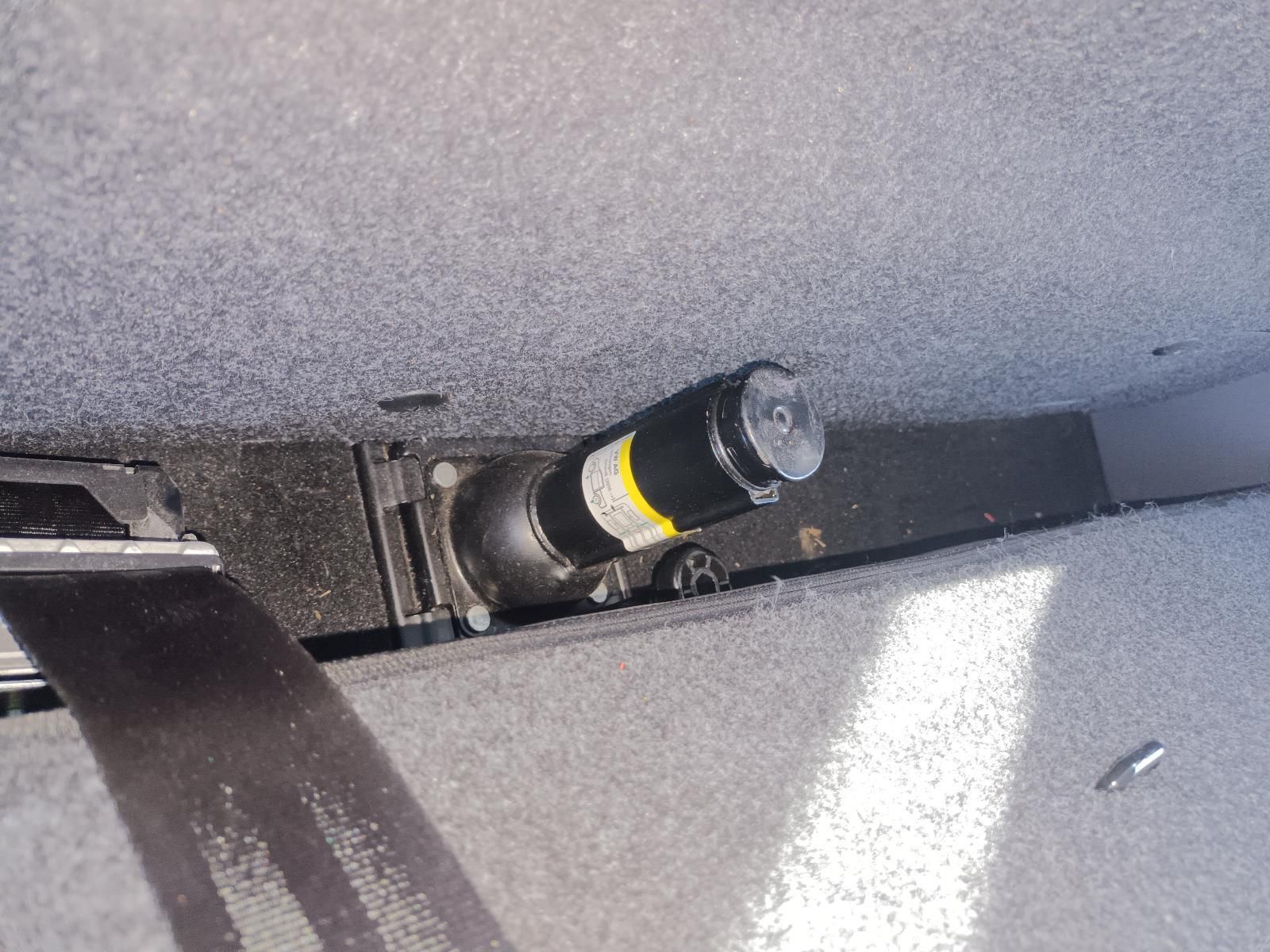 A Black Bottle with a Yellow Label is Sitting on a Gray Surface — South West 4WD Wreckers In Brisbane, QLD