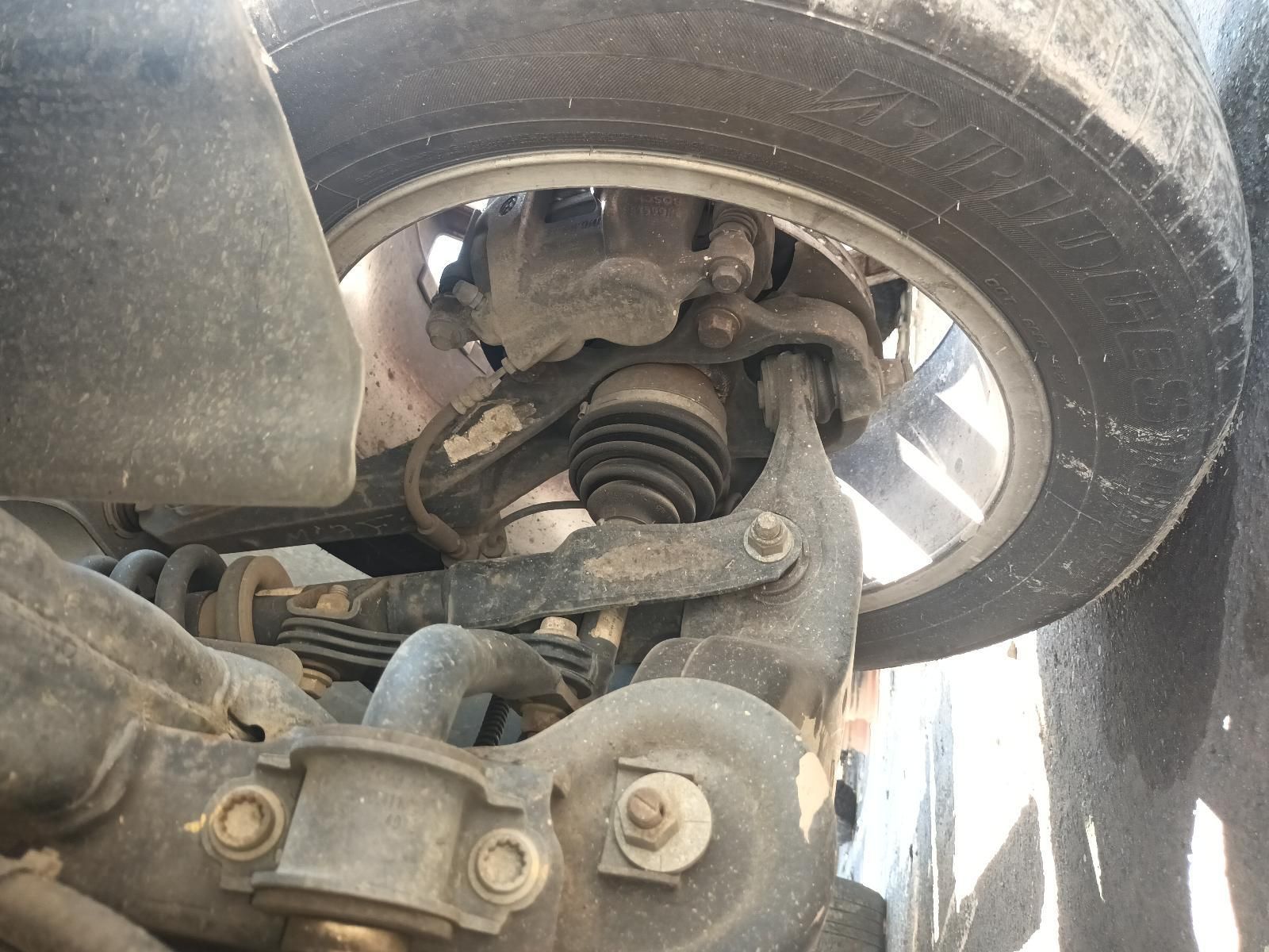A Close Up of the Underside of a Car with a Tire on It — South West 4WD Wreckers In Brisbane, QLD