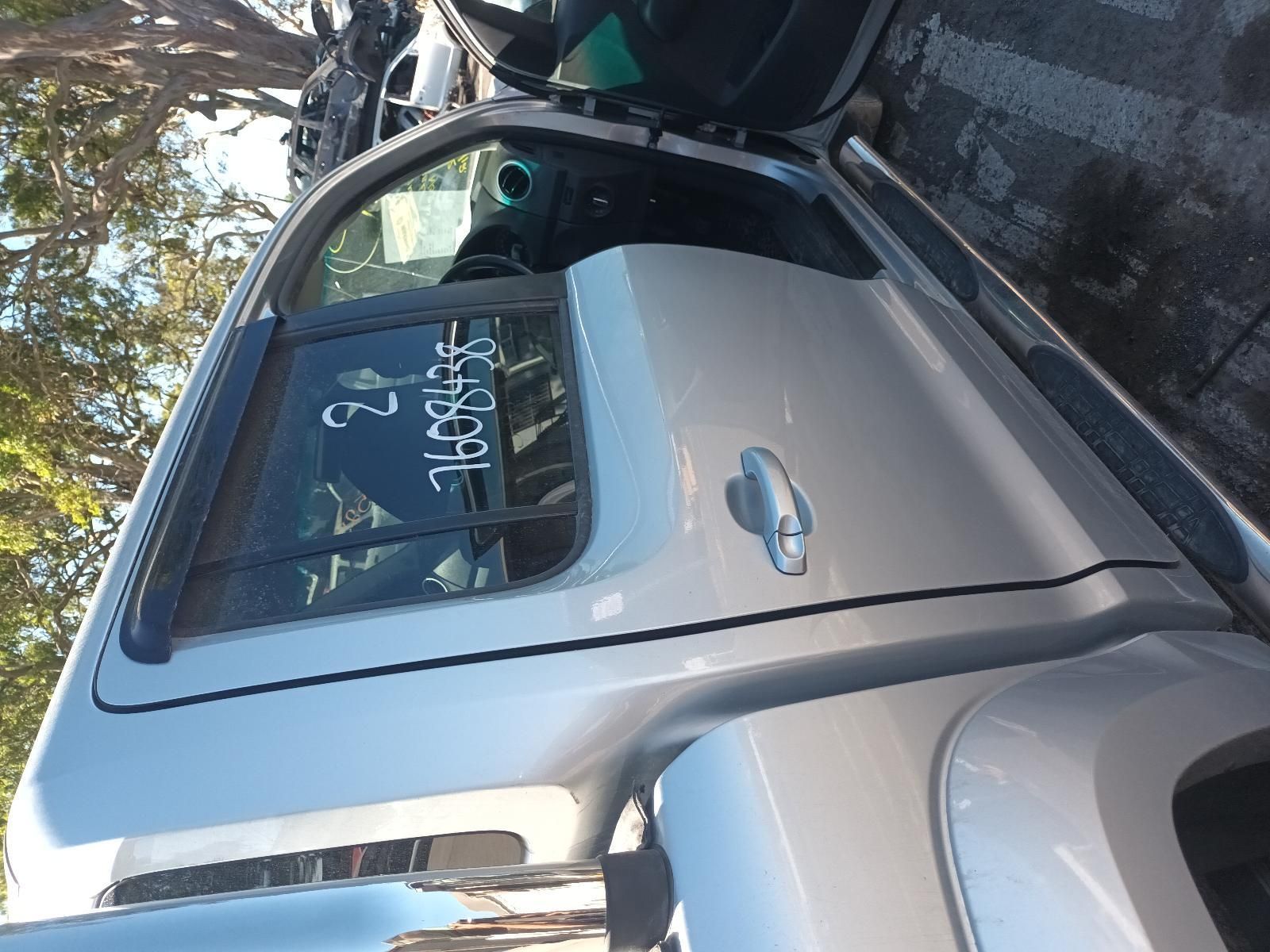A Silver Truck is Parked in a Parking Lot with the Door Open — South West 4WD Wreckers In Brisbane, QLD