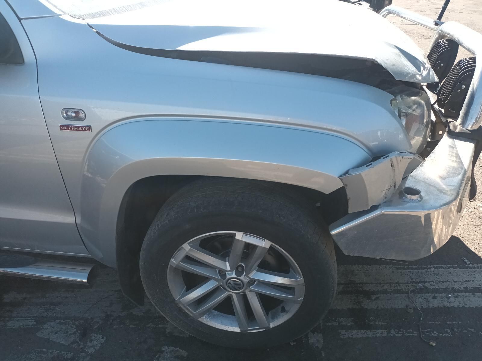 A Silver Truck with a Damaged Hood is Parked on the Side of the Road — South West 4WD Wreckers In Brisbane, QLD