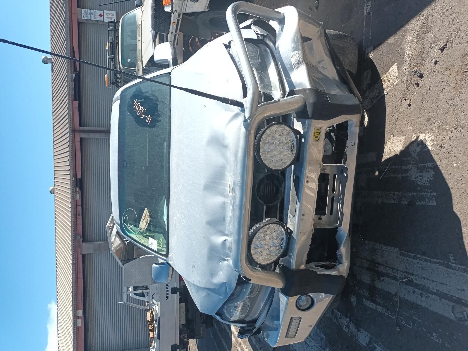 A Damaged Truck is Parked in Front of a Building — South West 4WD Wreckers In Brisbane, QLD