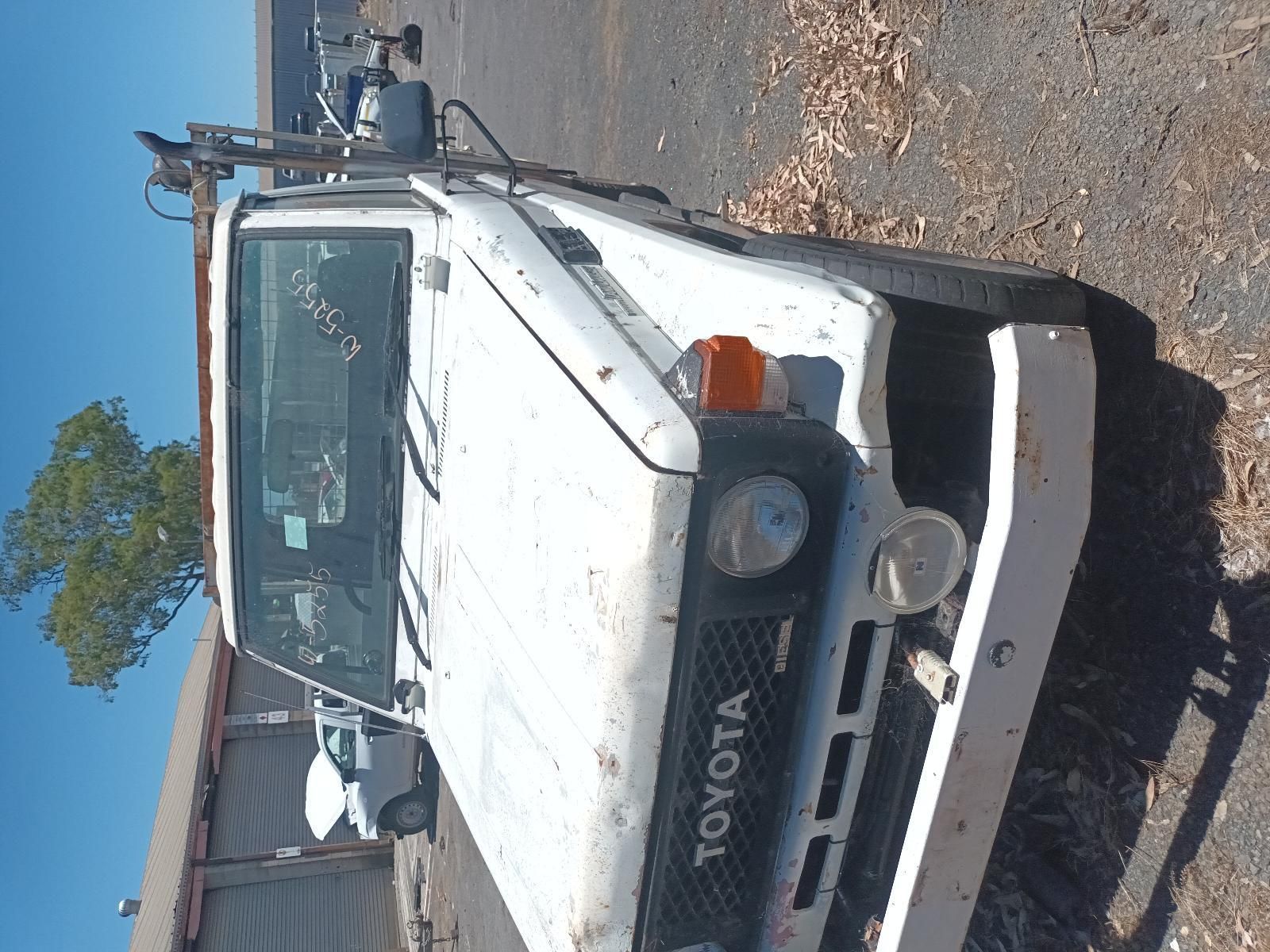 A White Toyota Truck is Parked on the Side of the Road — South West 4WD Wreckers In Brisbane, QLD