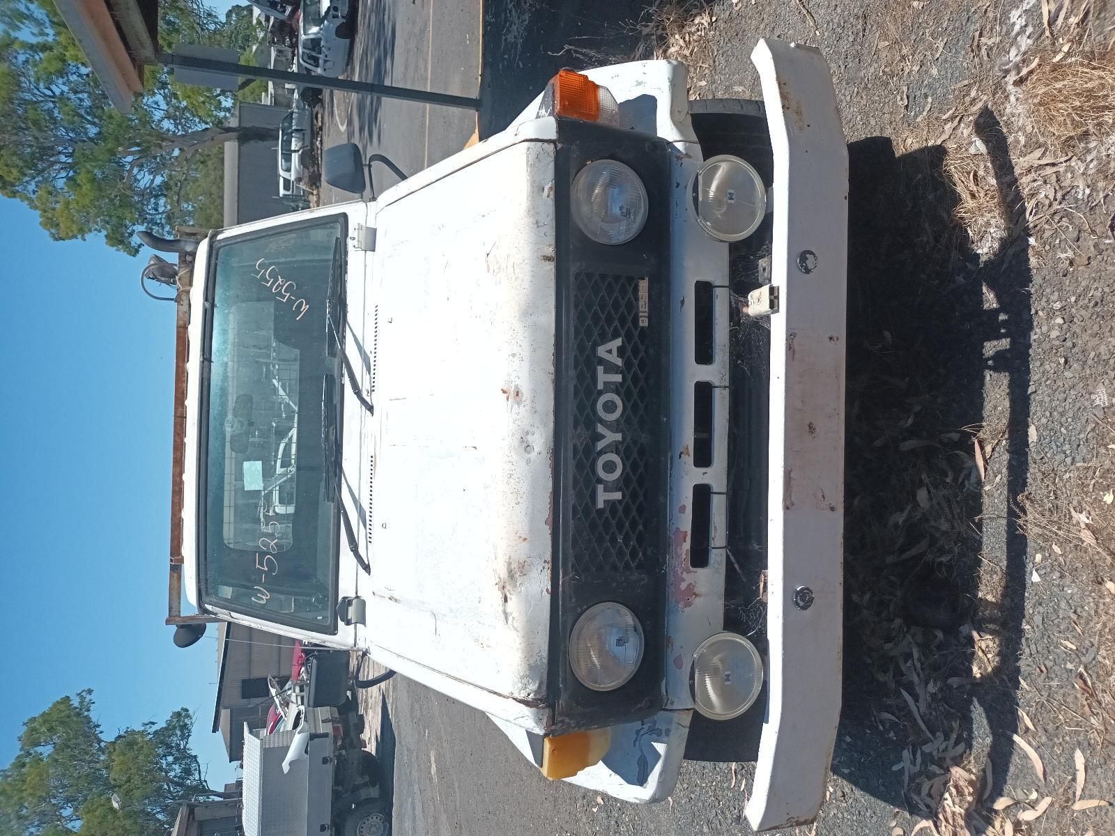 A White Toyota Truck is Parked on the Side of the Road — South West 4WD Wreckers In Brisbane, QLD