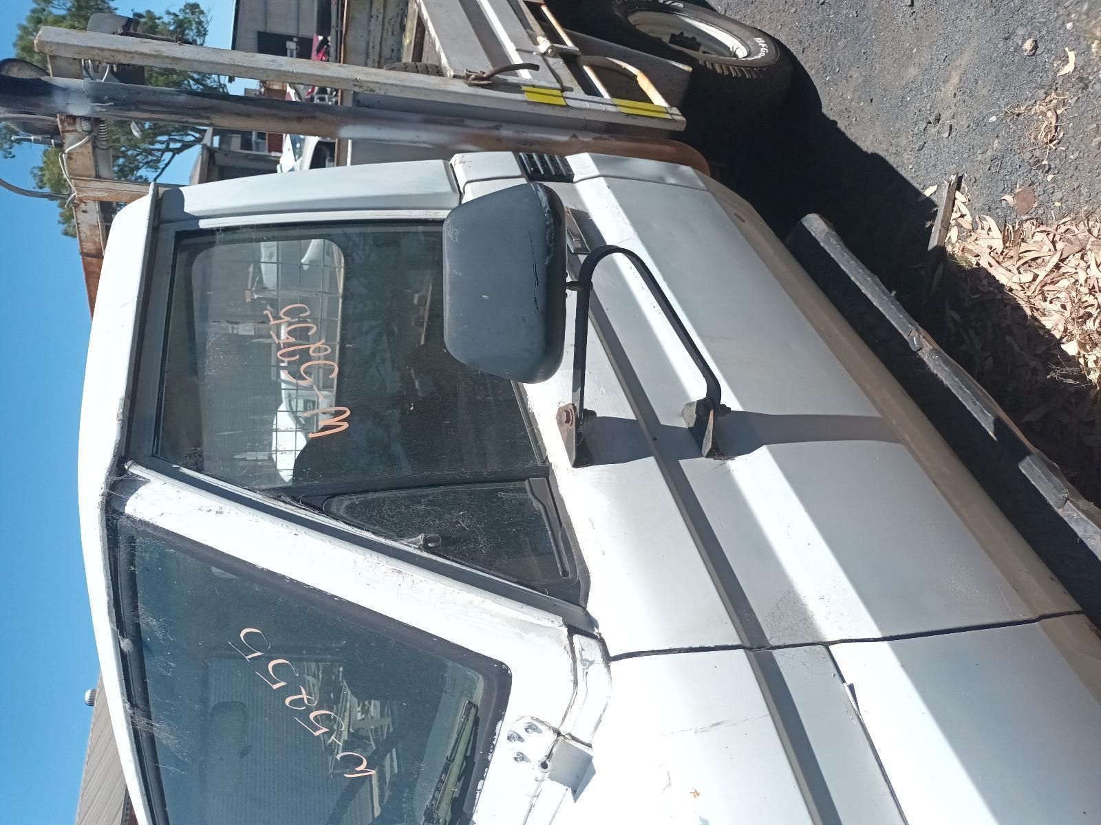 A White Truck is Parked on the Side of the Road — South West 4WD Wreckers In Brisbane, QLD