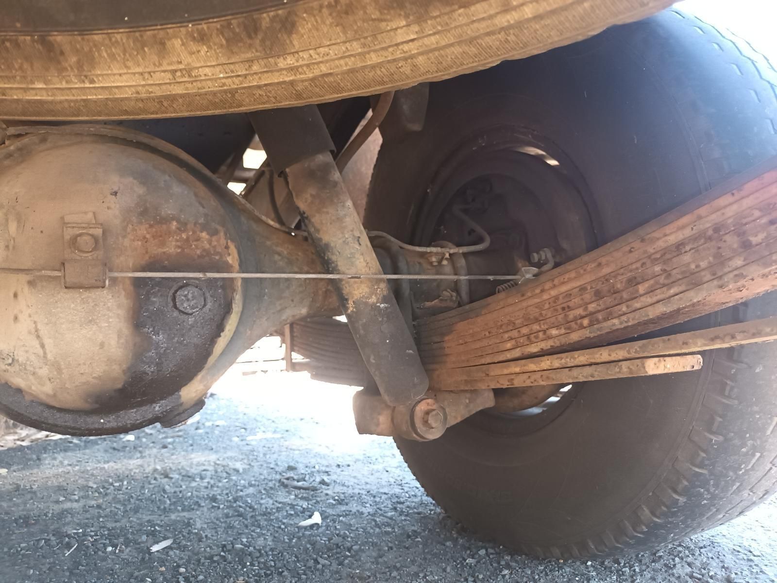 A Close Up of a Car 's Rear Suspension with a Tire in the Background — South West 4WD Wreckers In Brisbane, QLD
