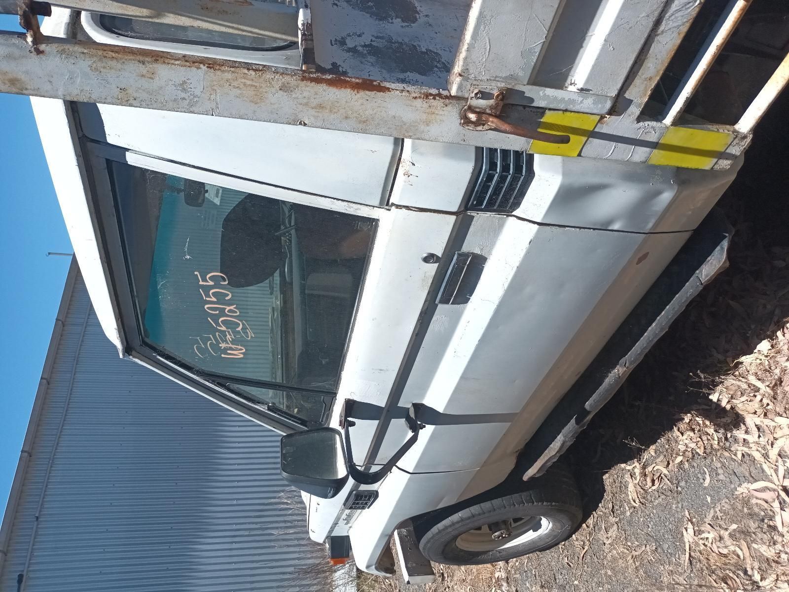 A White Truck is Parked on the Side of the Road — South West 4WD Wreckers In Brisbane, QLD