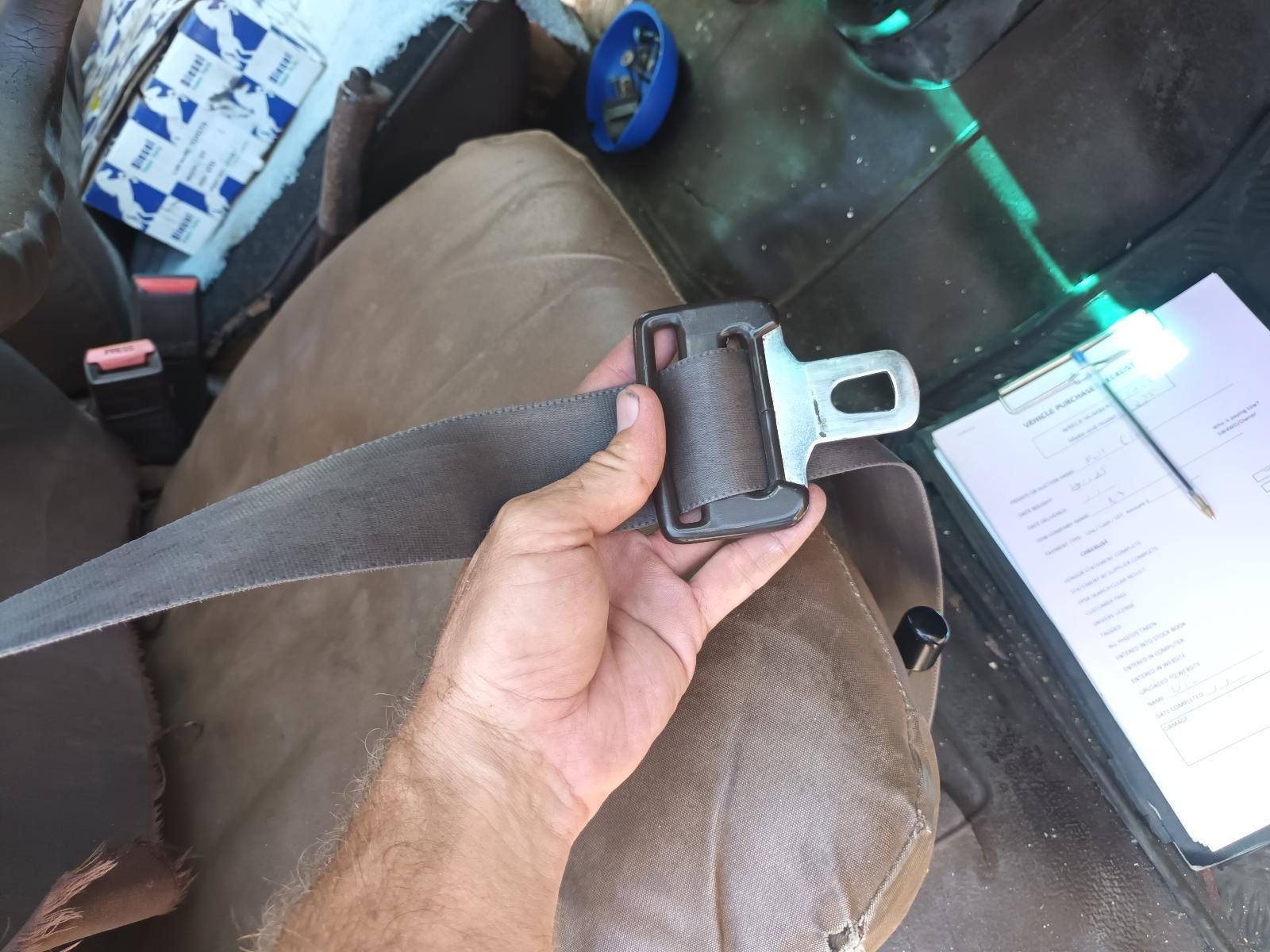 A Person is Holding a Seat Belt in Their Hand — South West 4WD Wreckers In Brisbane, QLD