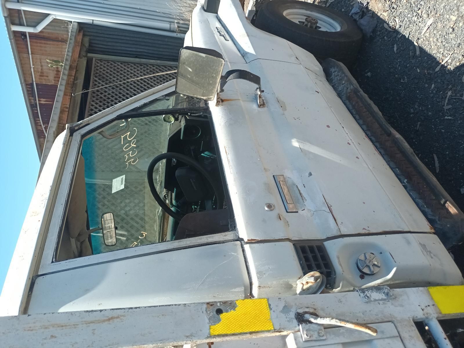 A White Truck is Parked on the Side of the Road — South West 4WD Wreckers In Brisbane, QLD