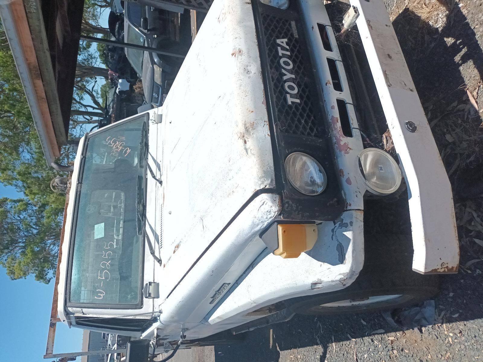 A White Toyota Truck is Parked on the Side of the Road — South West 4WD Wreckers In Brisbane, QLD