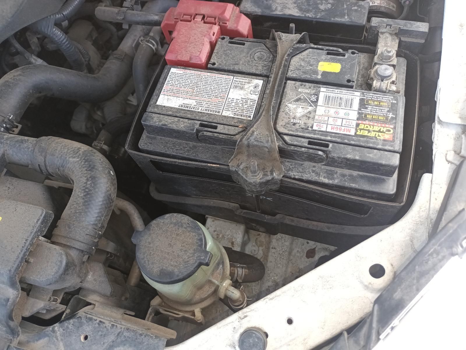 A Car Battery is Sitting Under the Hood of a Car — South West 4WD Wreckers In Brisbane, QLD