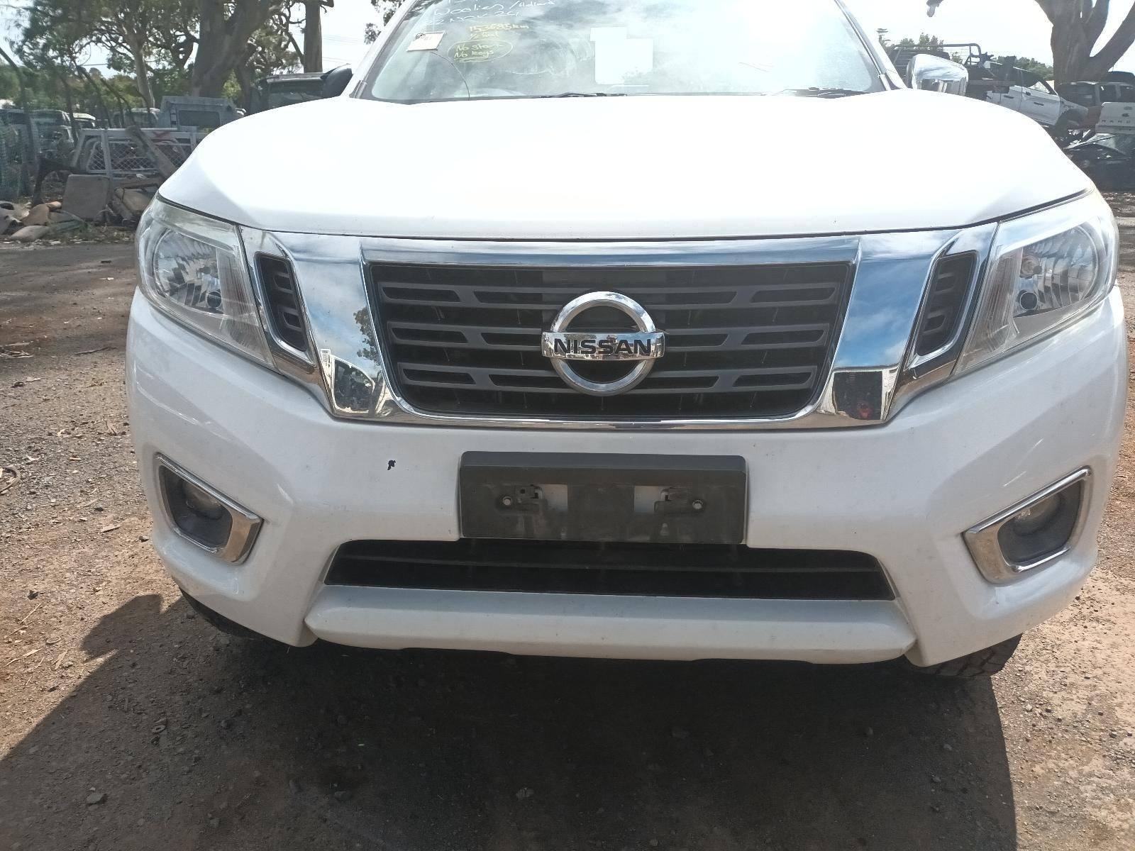 A White Nissan Truck is Parked on a Dirt Road — South West 4WD Wreckers In Brisbane, QLD