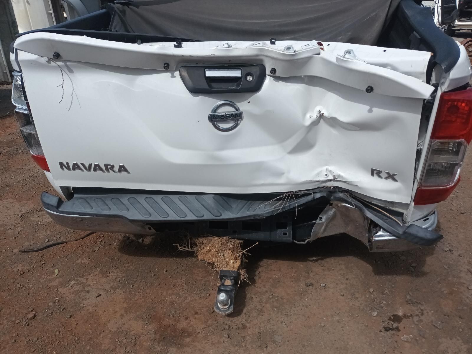 The Back End of a White Nissan Navara Pickup Truck is Damaged — South West 4WD Wreckers In Brisbane, QLD
