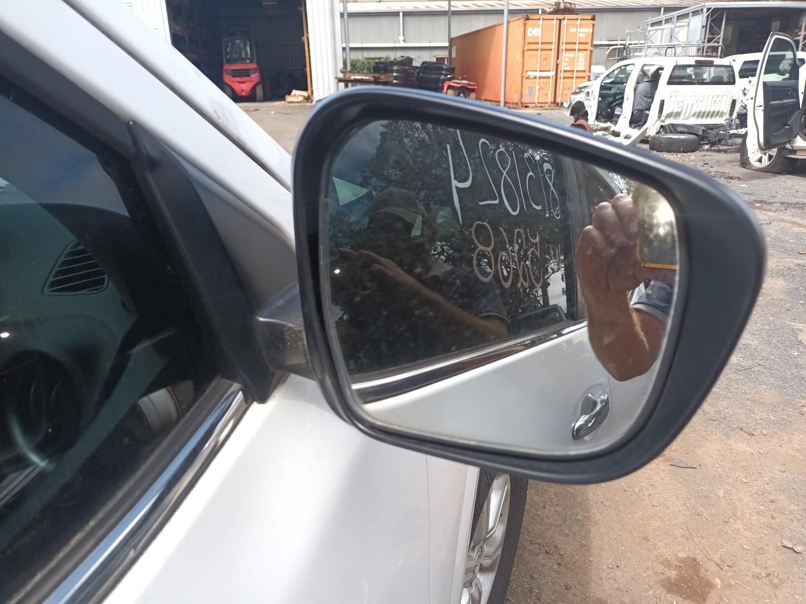 A Rear View Mirror on a White Car Shows a Person Taking a Picture — South West 4WD Wreckers In Brisbane, QLD