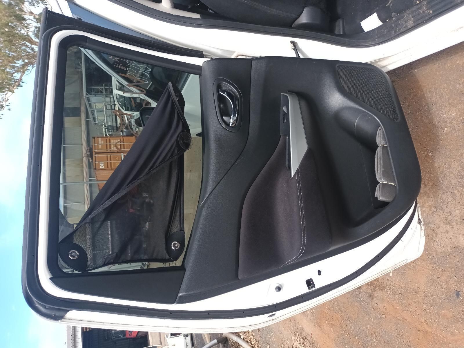 The Back Door of a White Car is Open and Sitting on the Ground — South West 4WD Wreckers In Brisbane, QLD