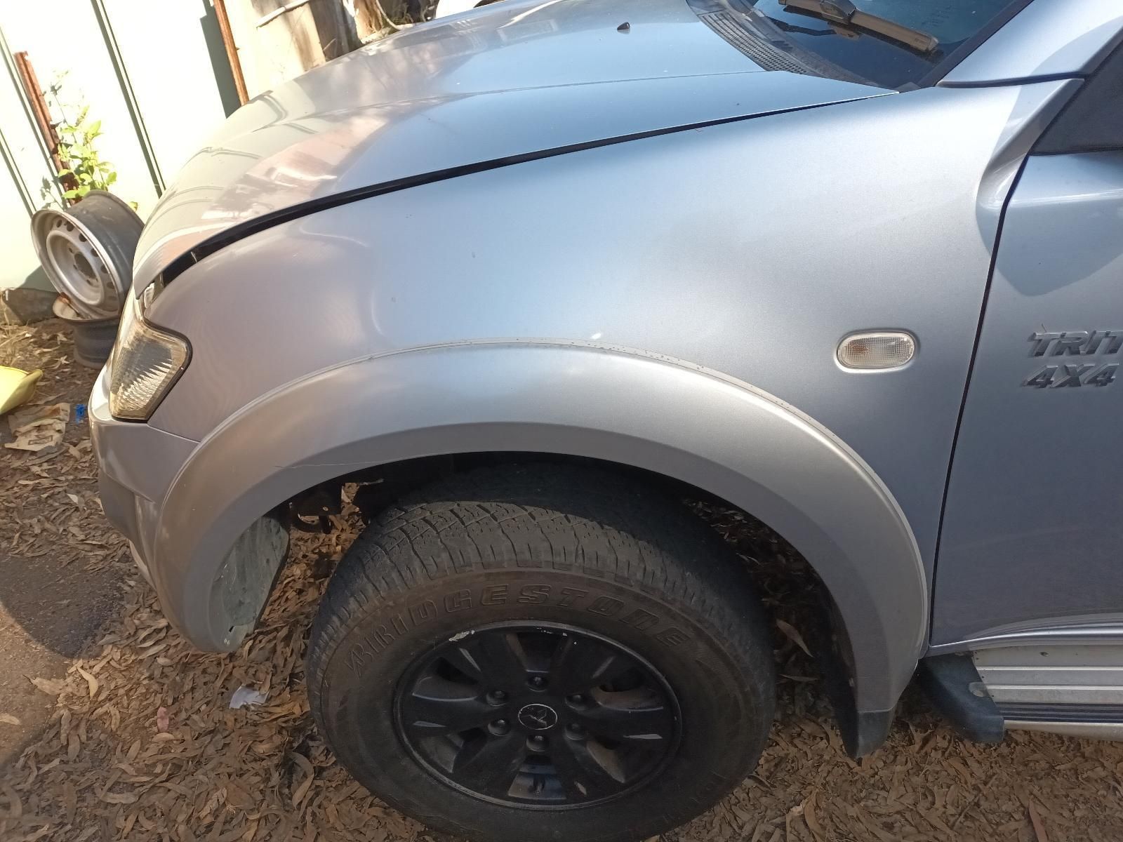 A Silver Truck with the Hood Down is Sitting on the Ground — South West 4WD Wreckers In Brisbane, QLD