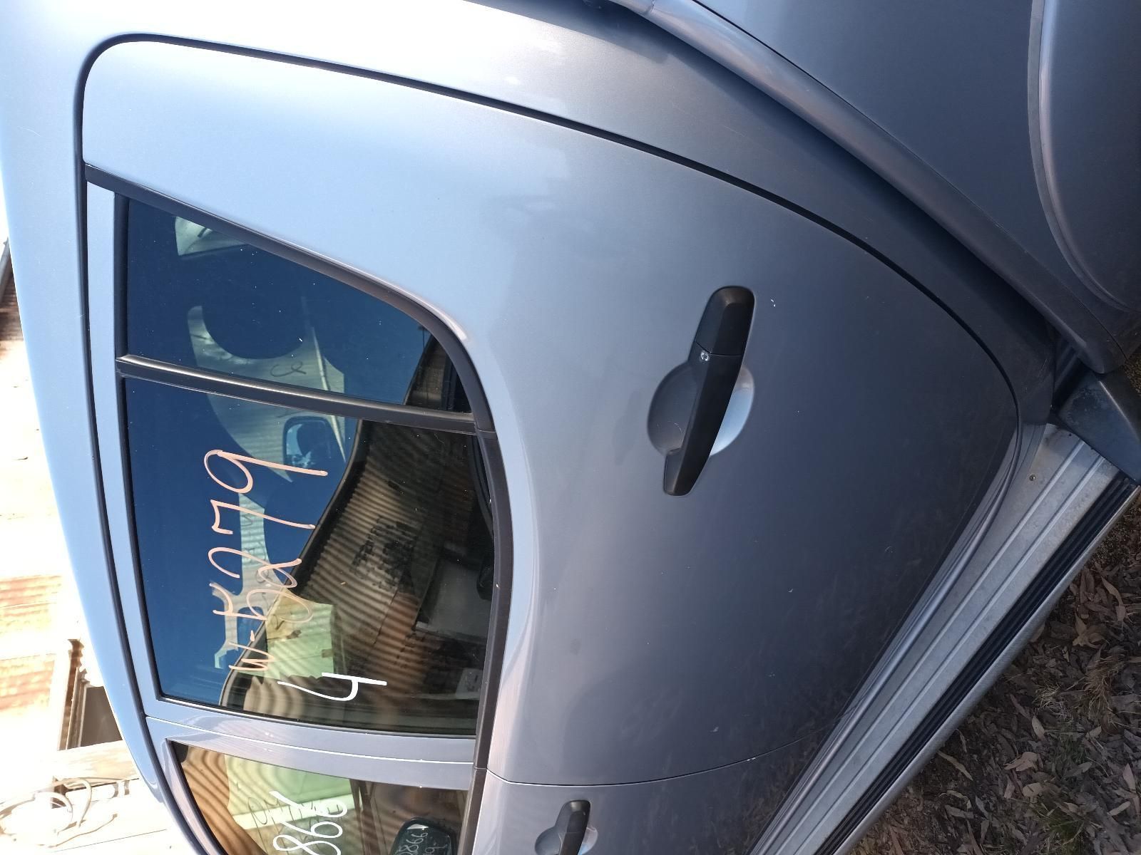 A Close Up of a Car Door with a Reflection of a Person in the Window — South West 4WD Wreckers In Brisbane, QLD